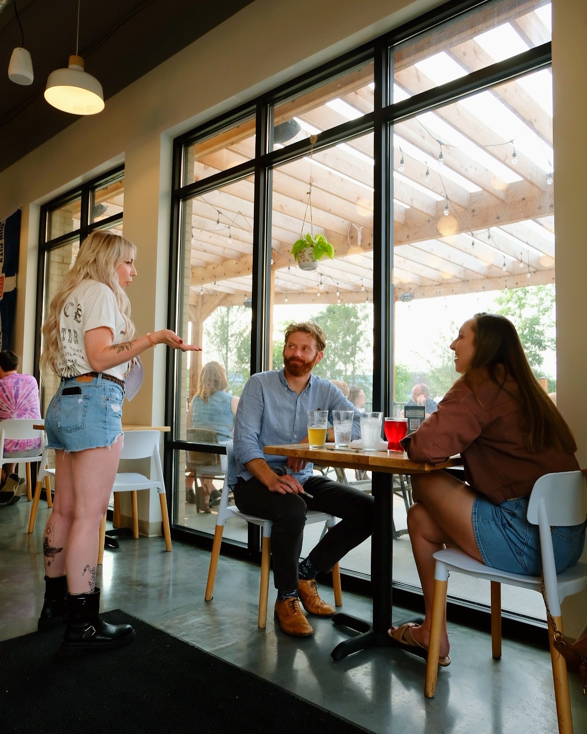 server talking to guests at Ash & Elm tap room