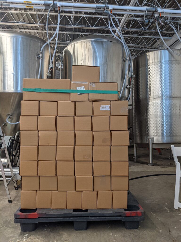 a pallet of boxes full of Ash & Elm cider ready to be shipped.