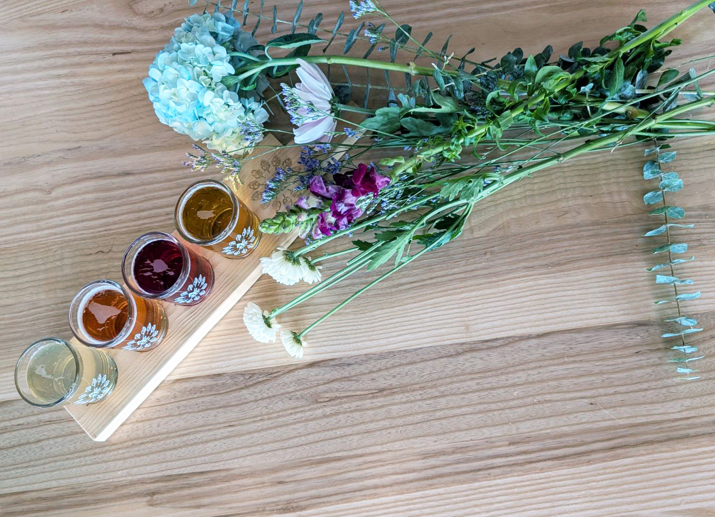 Ash & Elm cider tasting board with flowers